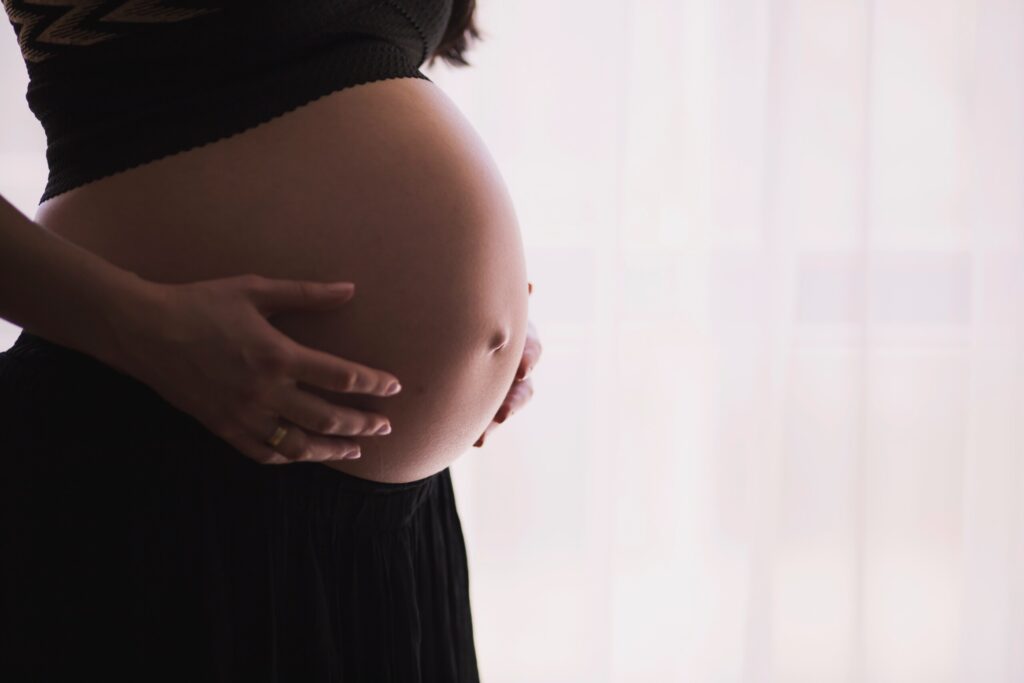 woman holding her pregnant stomach
